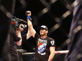 Mixed martial artist Gegard Mousasi celebrates after defeating Mark Munoz during the Ultimate Fighting Championship Fight Night at the O2 World in Berlin on May 31, 2014. (AFP PHOTO/DAVID GANNON)