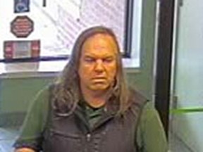 A bank surveillance image of a man sought in the alleged fraud of a senior in Burlington. (Halton Regional Police handout)