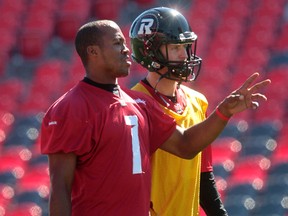 RedBlacks quarterback Henry Burris talks to new quarterback Joey Elliott during practice at TD Place in Ottawa Wednesday.  (Tony Caldwell/Ottawa Sun)