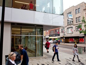 Pedestrians walk past Fanshawe College's Centre for Digital and Performance Arts, across the street from the former Kingsmill's department store, on Dundas Street in London, Ontario on Tuesday September 2, 2014. (CRAIG GLOVER, The London Free Press)