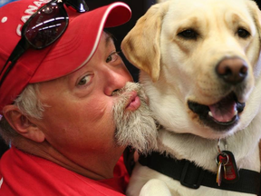 Medric Cousineau and his specially trained service dog named Thai. (Supplied photo)