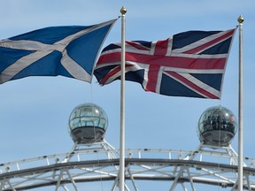 The Scottish saltire flag (L) and Union flag fly outside the Scottish Office, in central London.

REUTERS/Toby Melville