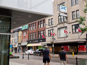 Pedestrians walk past Fanshawe College?s Centre for Digital and Performance Arts, across the street from the former Kingsmill?s department store, on Dundas St. (CRAIG GLOVER, The London Free Press)