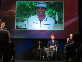 Team USA captain Tom Watson smiles as he announces that Keegan Bradley (on screen) will be one of his three picks to add to this year's Ryder Cup squad on Wednesday in New York. (Reuters)