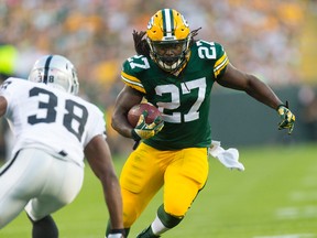 Green Bay Packers running back Eddie Lacy (27) rushes with the football as Oakland Raiders cornerback T.J. Carrie (38) defends during the first quarter at Lambeau Field in Green Bay on Aug. 22, 2014. (JEFF HANISCH/USA TODAY Sports)