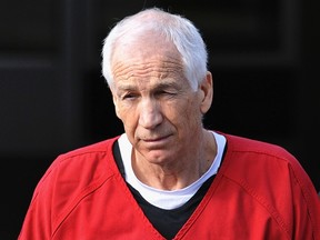 Jerry Sandusky (C) leaves the Centre County Courthouse after his sentencing in his child sex abuse case in Bellefonte, Pennsylvania in this file photo taken October 9, 2012. (REUTERS/Pat Little/Files)