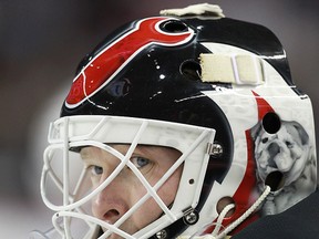 New Jersey Devils goalie Martin Brodeur scans the area during a game against the Calgary Flames on October 11, 2013. (Al Charest/Calgary Sun/QMI Agency)