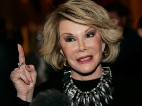 Comedian Joan Rivers talks to reporters as she arrives for a gala honoring the late stand-up comedian George Carlin. (REUTERS/Molly Riley/Files)