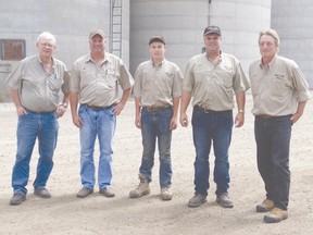 Bev Hill, Jim Hill, Luke Hill, Paul Hill and Pete Rowntree pose for a shot in front of the grain elevator at Varna Grain Ltd.