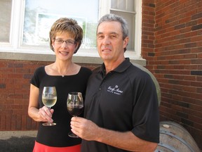 Sue and Mike Korpan, owners of Early Acres Estate Winery near Chatham, hold glasses of their award-winning wines. The winery has been named the feature industry of the month for September by the Chatham-Kent Chamber of Commerce.