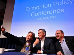 Alberta Progressive Conservative leadership candidates (L-R) Thomas Lukaszuk, Jim Prentice and Ric McIver take a "selfie" before speaking at the PC party's policy forum in Edmonton May 24, 2014.   REUTERS/Dan Riedlhuber