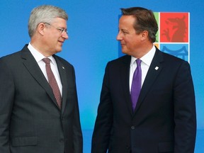 Britain's Prime Minister David Cameron greets Canada's Prime Minister Stephen Harper (L) at the start of the NATO summit at the Celtic Manor resort, near Newport, in Wales on September 4, 2014. (REUTERS/Andrew Winning)