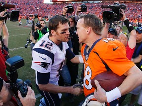 Tom Brady of the New England Patriots congratulates Peyton Manning of the Denver Broncos after the Broncos defeated the Patriots during the AFC Championship game at Sports Authority Field at Mile High on January 19, 2014. (Kevin C. Cox/Getty Images/AFP)