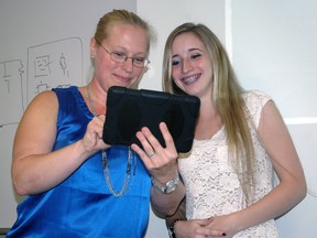 Fanshawe College instructor Ursula Goniarski, left, and student Shelbie Potter view an iPad in a child and youth worker class at the college's St. Thomas/Elgin campus. Ben Forrest/Times-Journal