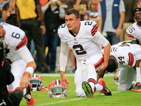 Cleveland Browns quarterback Johnny Manziel, stretching before a pre-season game last month, has registered the name Johnny Cleveland, to go with Johnny Football. Several other trademark names, tried for by fans, have been denied. (AFP)
