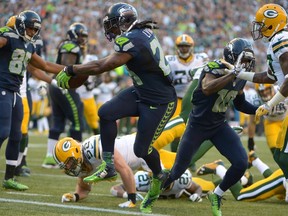 Seattle Seahawks running back Marshawn Lynch (24) scores on a 9-yard touchdown run in the second quarter against the Green Bay Packers at CenturyLink Field on Sep 4, 2014 in Seattle, WA, USA. (Kirby Lee/USA TODAY Sports)