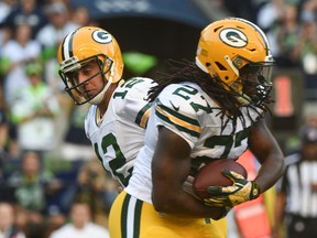 Packers quarterback Aaron Rodgers (left) hands the ball to running back Eddie Lacy (right) during first quarter NFL action against the Seahawks in Seattle on Thursday, Sept. 4, 2014. (Kyle Terada/USA TODAY Sports)