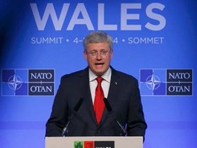 Prime Minister Stephen Harper speaks during a news conference on the second and final day of the NATO summit at the Celtic Manor resort, near Newport, in Wales September 5, 2014.      REUTERS/Yves Herman