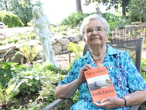Ruth Zavitz, holds a copy of Flight to the Frontier, her new fiction novel where she tells the story of an American Quaker family and their flight from persecution during the American Revolution to Ontario's Niagara Region. ELENA MAYSTRUK/ AGE DISPATCH/ QMI AGENCY
