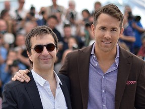 File photo of director Atom Egoyan (L) and cast member Ryan Reynolds pose during a photocall for the film "Captives" (The Captive) in competition at the 67th Cannes Film Festival in Cannes May 16, 2014.