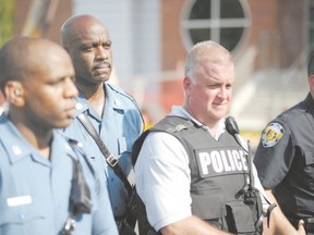 Missouri Highway Patrol officer listens to the concerns of protestors during the National March on Ferguson in Ferguson, Mo., Aug. 30, after Michael Brown, 18, was fatally shot by a police officer in the St Louis suburb Aug. 9. One letter writer thinks police are being criticized too harshly for the incident. However, another letter writer has a different view of police. (Agence France Presse)