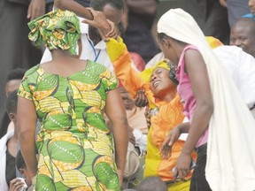 A woman overcome with grief is helped out of the the Amahoro stadium, in Kigali, Rwanda, during a ceremony April 7 marking the 20th anniversary of Rwanda?s genocide. Columnist Gwynne Dyer says it?s not uncommon for dictators like Rwanda?s president to have his enemies killed, but most of them aren?t congratulated by other nations and showered with aid. (SIMON MAINA, Agence France presse)