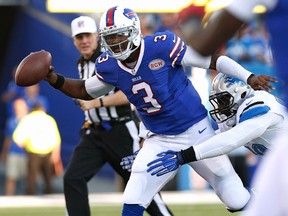 Buffalo Bills quarterback EJ Manuel tries to pass to wide receiver Sammy Watkins under pressure by Detroit Lions defensive end George Johnson during the first half at Ralph Wilson Stadium on August 28, 2014. (Kevin Hoffman/USA TODAY Sports)