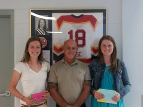 Caitlin Lee, left, and twin sister Erran, right, are co-recipients of this year's Christie Rose Scholarship. Rose, 18, from Fingal, died as a result of injuries sustained in an automobile accident in 2008. The Lee sisters are pictured with Rose's father, Dan. (Contributed photo)