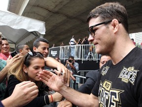 Ultimate Fighting Championship (UFC) fighter Michael Bisping (R) greets Brazilian fans after he attended an opening training session in downtown Sao Paulo January 16, 2013. (REUTERS/Paulo Whitaker)
