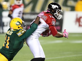 Odell Willis brings down Calgary's Marquay McDaniel (Ian Kucerak, Edmonton Sun).