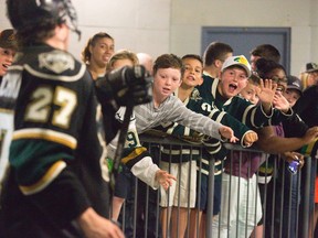 Fans greet Brett Welychka as he leaves the dressing room to take to the ice for the third period of their OHL exhibition opener against the Sarnia Sting at the Budweiser Gardens on Friday night.  (DEREK RUTTAN, The London Free Press)