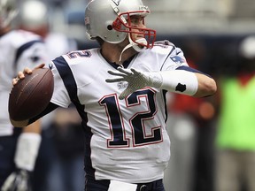 Patriots QB Tom Brady is on the team's injury report, but he says he will suit up on Sunday. (Getty Images/AFP)