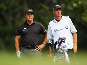Phil Mickelson of the United States stands beside caddie Jim Mackay as he prepares to hit his tee shot on the 13th hole during the second round of the BMW Championship at the Cherry Hills Country Club on September 5, 2014. (Jamie Squire/Getty Images/AFP)