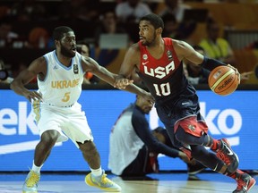 US guard Kyrie Irving vies with Ukraine's guard Eugene Jeter during the 2014 FIBA World basketball championships group C match at the Bizkaia Arena in Bilbao on September 4, 2014. (AFP PHOTO/ANDER GILLENEA)