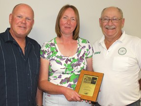 BMO area manager Gerry Lowe (left) presents Doug and Judy Krall with the BMO Family Farm Award. The Kralls farm in Enniskillen Township and with their son represent four generations in local agriculture.
JOHN PHAIR/ QMI Agency