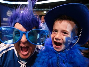 Brian Vettman and his son Jackson Vettman all decked out in Leaf gear at Fan Fest. A trio of Toronto Maple Leafs greats were the first to be honoured with bronzed statues on Sept. 6, 2014. (Craig Robertson/Toronto Sun)