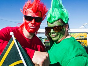 Brent Pickrell, left, from Calgary, and Leah Pickrell, right, from St. Paul, show their colours during the Edmonton Eskimos' CFL football game against the Calgary Stampeders at Commonwealth Stadium in Edmonton, Alta., on Saturday, Sept. 6, 2014. Codie McLachlan/Edmonton Sun/QMI Agency