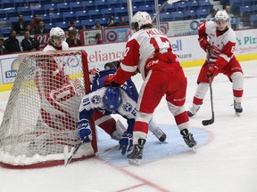 Sudbury Wolves forward Nathan Pancel takes some abuse in front of the Soo Greyhounds goal Friday night at Sudbury Community Arena. The Wolves bounced back Saturday to beat the Hounds 7-4.