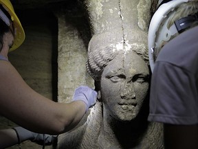 This handout picture released by the Greek Ministry of Culture on September 7,  2014 shows one of the two statues of a Caryatid inside the Kasta Tumulus in ancient Amphipolis, northern Greece. The excavations at the ancient tomb of Amphipolis uncovered two Caryatids- half-bodied marble female statues.  (AFP PHOTO /GREEK MINISTRY OF CULTURE)