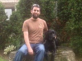 Chad Miron, 30, with his service dog, Norman. (Supplied photo)