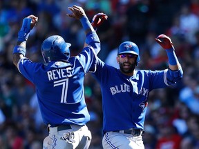 Jose Bautista #19 of the Toronto Blue Jays celebrates his three-run home run with Jose Reyes #7 against the Boston Red Sox in the fifth inning at Fenway Park on September 7, 2014 in Boston, Massachusetts.  (Jim Rogash/Getty Images/AFP)