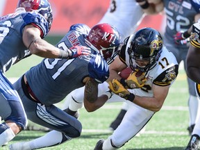 Winston Venable of the Montreal Alouettes tackles Luke Tasker of the Hamilton Tiger-Cats during their game on Sept. 7. (AFP)