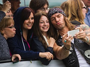 Clayton Bellamy of the Road Hammers makes a duck face while posing with fans on the green carpet during the 2014 Canadian Country Music Association Awards at Rexall Place in Edmonton, on Sunday. (CODIE MCLACHLAN/Edmonton Sun)