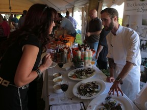 Sous chef Josh Bourgoyn of the Gananoque Inn and Spa explains how the restaurant's sushi is made entirely of locally grown ingredients at the United Way of Kingston, Frontenac Lennox and Addington's annual Fare for Friends at CFB Kingston on Sunday. (ELLIOT FERGUSON/THE  WHIG-STANDARD)