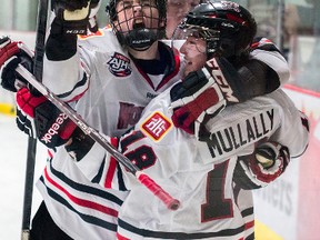 Joel Kocur (left) and Evan Warmington (behind) congratulate John Mullally after his game winning goal that put the Wolverines ahead of the Spruce Grove Saints in the closing minutes of the third period on Friday, Sept. 5. Whitecourt won 5-4. Bryan Passifiume photo | QMI Agency