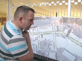 Carson Warrener takes a close look at the streetscape design plan for downtown Chatham that was on display at the Civic Centre on Sept. 4.