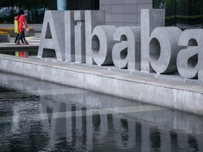 People walk at the headquarters of Alibaba in Hangzhou, Zhejiang province, in this April 23, 2014 file photo. Chinese e-commerce company Alibaba Group Holding Ltd said its expects to price its initial public offering at between $60 and $66 per American Depository share, September 5, 2014. (REUTERS/Chance Chan)
