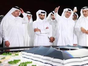 Secretary-General Hassan Al-Thawadi (3rd L) of Qatar's Supreme Committee for Delivery and Legacy, the nation's 2022 World Cup organising committee, speaks during a news conference to announce the start of work on the Al-Khor Stadium in Al-Khor June 21, 2014. (REUTERS/Mohammed Dabbous)