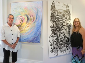 Kim Lichty, left, stands with one of her oil on canvas paintings from her New Work collection at Gallery in the Grove. Susan VanVeldhuisen is also pictured with one of her India ink on wood works from Inside Out. Both artists are part of an exhibition at the Bright's Grove gallery that runs until Sept. 27. TYLER KULA/ THE OBSERVER/QMI AGENCY