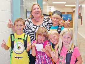 Students at Upper Thames Elementary School (UTES) in Mitchell and principal Paula Robinson gave the first day back at school a thumbs up last Tuesday, Sept. 2. Joining Robinson are, from left, Tyler Smuck, Charlee Gethke, Ethan Meinen, Katrina Bolinger and Brandon Bieber (back). Hundreds of students from kindergarten to post-secondary returned to school last week. KRISTINE JEAN/MITCHELL ADVOCATE